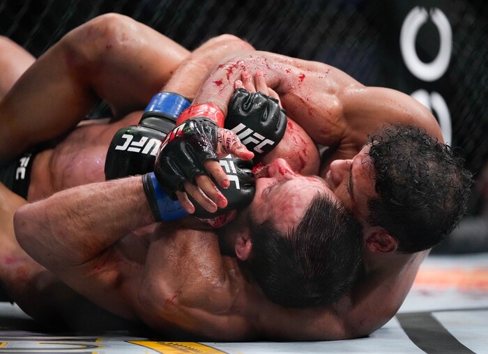 (Francisco Kjolseth | The Salt Lake Tribune) No. 6 ranked middleweight Paulo Costa of Brazil, right, has a bloody round with former middleweight champion Luke Rockhold of the United States during their UFC 278 mixed martial arts bout in the octagon at Vivint Arena in Salt Lake City on Saturday, Aug. 20, 2022. 