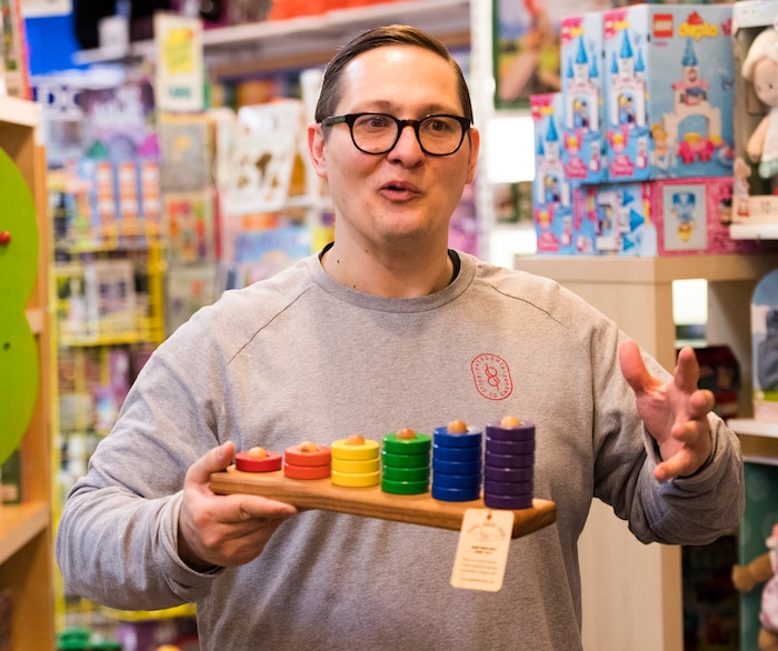 (Rick Egan  |  The Salt Lake Tribune)       Casey Sartain talks about some of the unique toys they sell at The Tutoring Toy on Foothill Drive, such as Papa Don's home made toys from Oregon, Thursday, March 22, 2018.