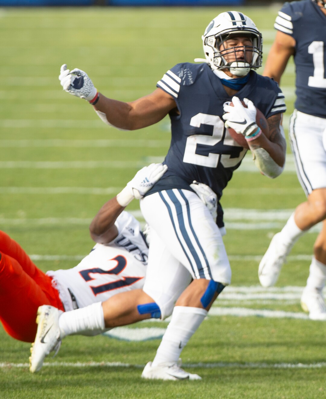 (Rick Egan  |  The Salt Lake Tribune)    Brigham Young running back Tyler Allgeier (25) runs for a Cougars as UTSA Roadrunners cornerback Ken Robinson (21) defends, in football action between the Brigham Young Cougars and the UTSA Roadrunners, at Lavell Edwards stadium, Saturday, Oct. 10, 2020.