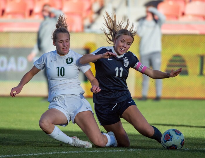 (Francisco Kjolseth  |  The Salt Lake Tribune) Kelly Bullock #10 of Olympus slides in for the ball alongside Gabrielle Carlson #11 of Bonneville as they compete in their 5A high school girls championship game at Rio Tinto Stadium in Sandy on Friday, Oct. 23, 2020. Bonneville went on to win 1-0 in overtime.
