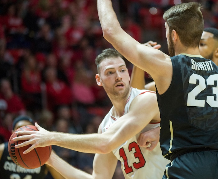 (Rick Egan  |  The Salt Lake Tribune)  Utah Utes forward David Collette (13) looks to pas, as Colorado Buffaloes forward Lucas Siewert (23) defends, in PAC-12 basketball action at the Jon M. Huntsman Center, Saturday, March 3, 2018.
