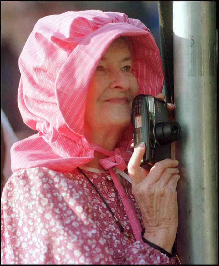 Rick Egan  | Tribune File Photo 

Margaret Rowland, Spanish Fork, UT, waits to sneak a snap of the Prophet Gordon B. Hinckley as he speaks to the crowds at Miller Park in Florence, Nebraska.