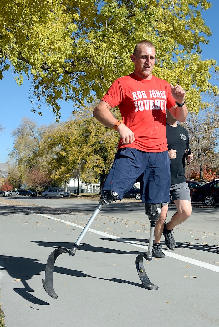 Al Hartmann | The Salt Lake Tribune)
Rob Jones, a retired Marine Corps Sergeant who lost both legs when he stepped on an improvised explosive device in Afghanistan, runs a marathon, (26.2) miles in Liberty Park in Salt Lake City Wednesday Oct. 25. He won a Bronze Medal in the Paralympics and he wis the first and only double above the knee amputee to ride a normal bicycle 5,180 miles across America. Now, he is set to run 31 marathons in 31 days in 31 major cities. Starting in London on October 12th, and continuing in the United States and Toronto, he will run 26.2 miles in the selected city on his own, travel to the next city, and repeat, ending appropriately on Veterans Day in our Nation’s Capital. His motto, “Survive. Recover. Live.”