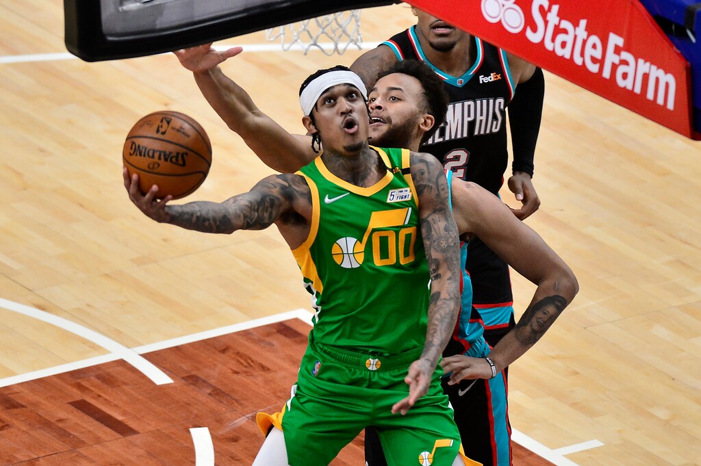 Utah Jazz guard Jordan Clarkson (00) shoots in front of Memphis Grizzlies forward Kyle Anderson during the first half of an NBA basketball game Wednesday, March 31, 2021, in Memphis, Tenn. (AP Photo/Brandon Dill)