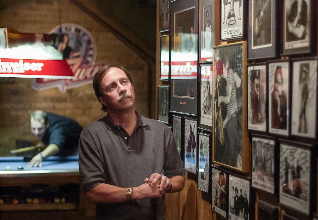 (Trent Nelson | The Salt Lake Tribune) John Paul Brophy Jr., one of the owners of Salt Lake City's Dead Goat Saloon, inside the bar standing near autographed celebrity portraits in September, 2003. Brophy died at the age of 74 on April 28, 2025.