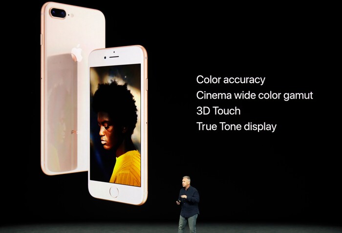 Phil Schiller, Apple's senior vice president of worldwide marketing, shows the new iPhone 8 at the Steve Jobs Theater on the new Apple campus on Tuesday, Sept. 12, 2017, in Cupertino, Calif. (AP Photo/Marcio Jose Sanchez)