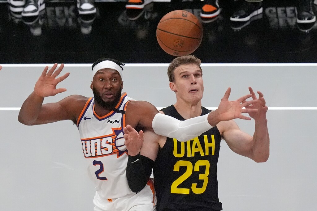 Phoenix Suns forward Josh Okogie (2) and Utah Jazz forward Lauri Markkanen (23) battle for a rebound during the first half of an Emirates NBA Cup basketball game Tuesday, Nov. 12, 2024, in Salt Lake City. (AP Photo/Rick Bowmer)