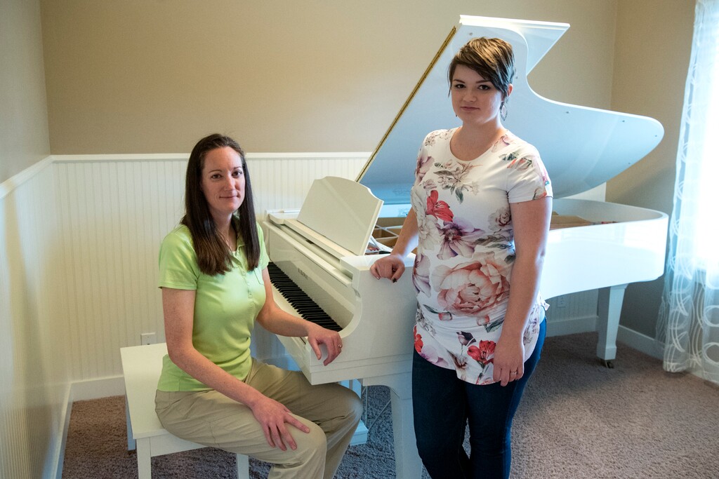 (Chris Detrick | The Salt Lake Tribune) Brittany Farnsworth, left, and Camille Weber at Farnsworth's home in Bluffdale. They had not previously met but agreed to be photographed together. Weber, a senior at Utah State University, filed a Title IX complaint against a USU professor last year and described an "extreme culture of favoritism" within the piano department. Farnsworth, who attended USU from 1998 to 2000, says she was denied lessons she had paid for and heard sexist talk within the department.
