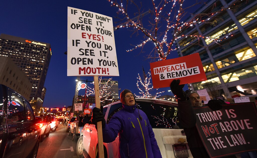 (Francisco Kjolseth | The Salt Lake Tribune) Greg Bishop, left, and Rion Locke join other activists gathered outside the Wallace F. Bennett Federal Building on Tuesday, Dec. 17, 2019, as part of the nationwide ÒNobody Is Above the LawÓ rallies, the day before the U.S. House of Representatives votes to impeach Donald Trump for high crimes and misdemeanors. The rally in Salt Lake City is one of more than 500 rallies occurring nationwide in all 50 states.