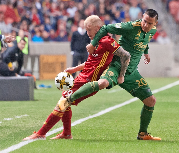 (Michael Mangum  |  Special to the Tribune)  Real Salt Lake midfielder Luke Mulholland (19) shields the ball from Portland Timbers midfielder David Guzman (20) as it rolls out of bounds during their MLS match at Rio Tinto Stadium in Sandy, UT on Saturday, September 16, 2017.
