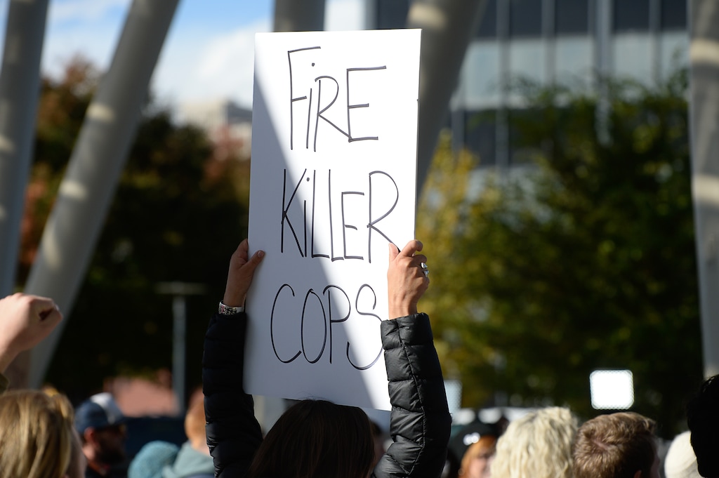 (Francisco Kjolseth  |  The Salt Lake Tribune)  People gather to demand justice for the killing of Patrick Harmon who was shot by police on Aug. 13, when he tried to flee after being stopped on his bicycle. Around 150 people gathered for the rally at the Salt Lake City Public Safety Building on Sunday, Oct. 8, 2017, demanding Salt Lake County district attorney Sim Gill be fired for his "justified," ruling in the case.
