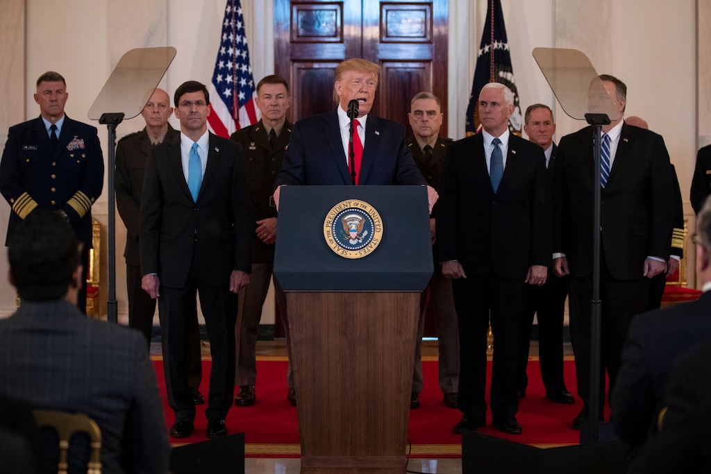 (Evan Vucci | AP) President Donald Trump addresses the nation from the White House on the ballistic missile strike that Iran launched against Iraqi air bases housing U.S. troops, Wednesday, Jan. 8, 2020, in Washington, as Secretary of Defense Mark Esper, Chairman of the Joint Chiefs of Staff Gen. Mark Milley, Vice President Mike Pence, and Secretary of State Mike Pompeo, and others look on.
