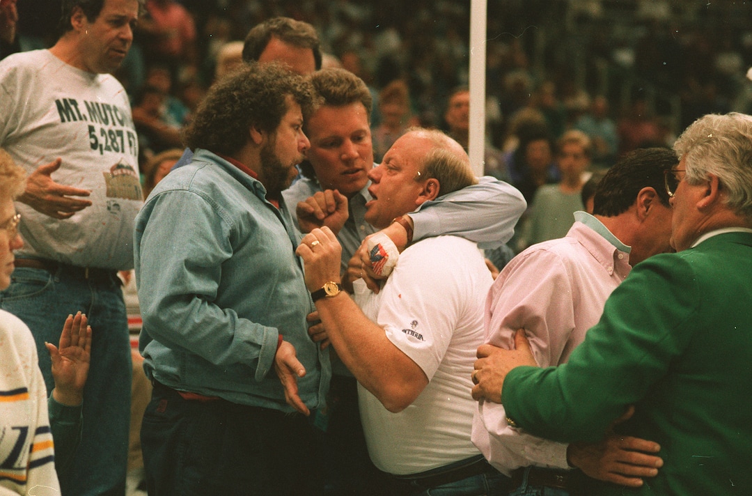(Steve Griffin  |  Tribune file photo) Jazz owner Larry H. Miller gets into an argument with a Nuggets fan during a game in 1994.