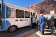 (Andrew Christiansen | The Times-Independent) Passengers board the Moab-Arches shuttle at the Arches Visitor Center on Oct. 15. Riders interviewed that day described experiences ranging from short waits and easy navigation to delays that limited their plans.