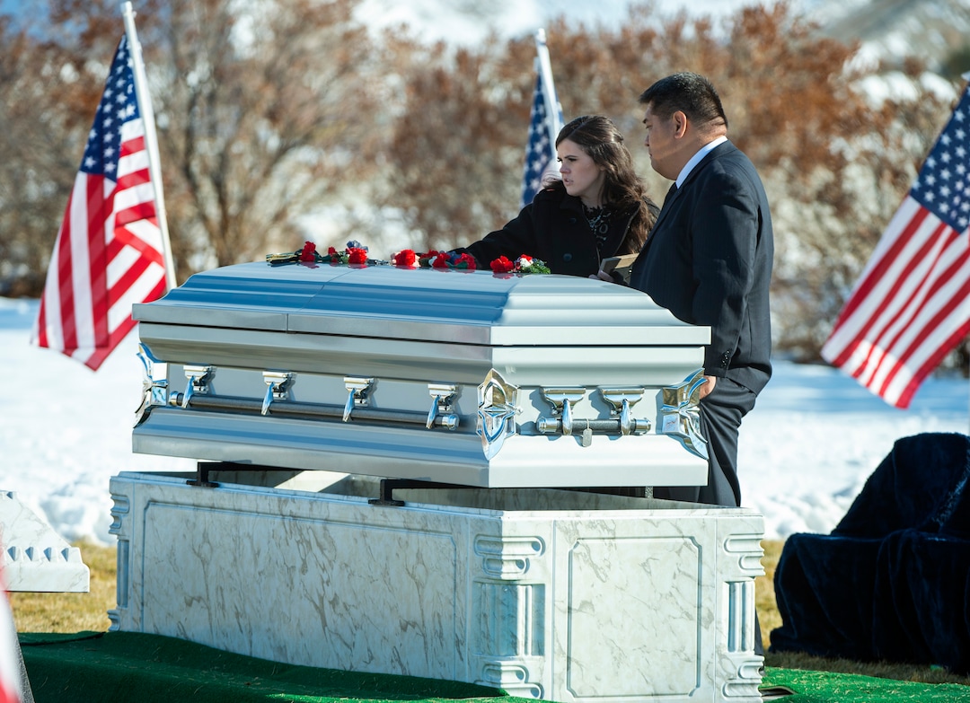 (Rick Egan | The Salt Lake Tribune) McKenzie Fuchigami stands by the casket of her husband, Army Chief Warrant Officer 2 Kirk T. Fuchigami, Jr., who was killed last month in Afghanistan,with Kirk Fuchigami, Sr., at the Brigham City Cemetery, Monday, Dec. 9, 2019.