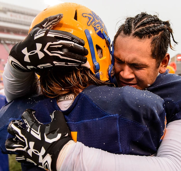 (Trent Nelson | The Salt Lake Tribune)  Orem's Tausili Fiatoa (34) embraces teammate Orem's Remington Hill (8) as Orem faces Mountain Crest in the Class 4A High School State Football Championship game in Salt Lake City, Friday November 17, 2017.