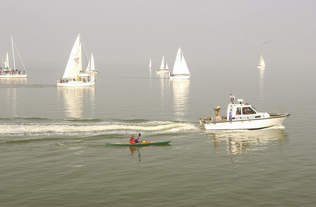 (Ryan Galbraith | The Salt Lake Tribune) The Olympic Torch travels across the Great Salt Lake on Feb. 6, 2002.