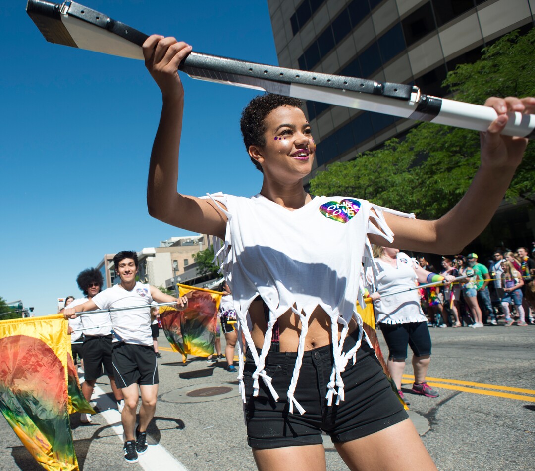 (Rick Egan  |  The Salt Lake Tribune)   Kasey Kirklan twirls a gun as she marches with West Hugh, in the Utah Pride Parade, in Salt Lake City, Sunday, June 3, 2018.