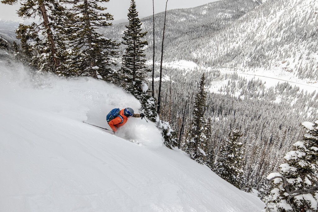 (Alterra Mountain Resort) A skier enjoys powder and a view of Interstate 70 at Arapahoe Basin in Keystone, Colo. Alterra Mountain Resorts is in the process of buying the independently owned ski area, which is usually one of the nation's first to open and last to close.