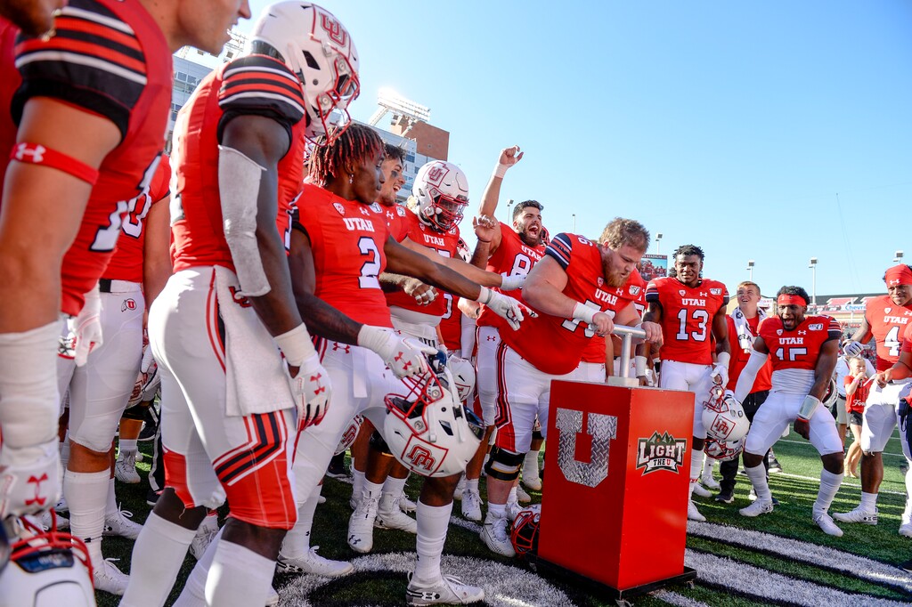 (Leah Hogsten  |  The Salt Lake Tribune) The Utes celebrate the 31-0 win as Utah Utes offensive lineman London Bartholomew (76) lights the "U" after defeating the Idaho State Bengals on Saturday at Rice-Eccles Stadium.