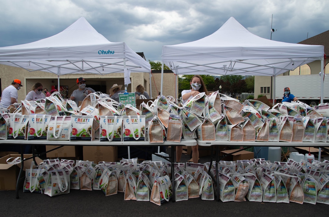 (Francisco Kjolseth  |  The Salt Lake Tribune) Paige Smith lends a helping hand as the third “Miracle Project” for the nonprofit foundation which raises money to purchase food produced by Utah farmers and then gives to residents in need, takes place at the Utah State Fairpark in Salt Lake City on Monday, July 27, 2020. The food donation from the Utah Farm Bureau’s “Farmers Feeding Utah” program provided food for 600 individuals and families who have recently become unemployed due to the coronavirus.