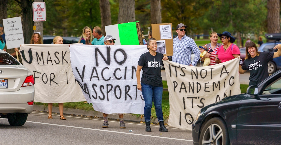 (Leah Hogsten | The Salt Lake Tribune) Protesters waving American flags and holding signs decrying mask and vaccine mandates gathered along the curb of 700 East in Liberty Park Saturday, making Salt Lake City one of dozens of cities around the world protesting public health-related restrictions, Sept. 18, 2021.
