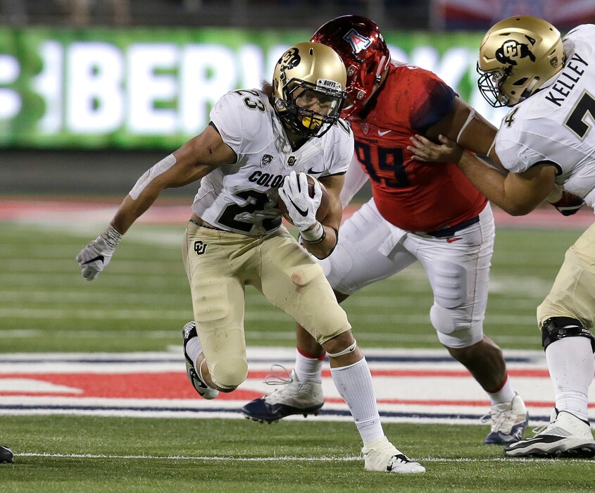 Colorado running back Phillip Lindsay (23) runs for a first down during the second half of an NCAA college football game against Arizona, Saturday, Nov. 12, 2016, in Tucson, Ariz. (AP Photo/Rick Scuteri)