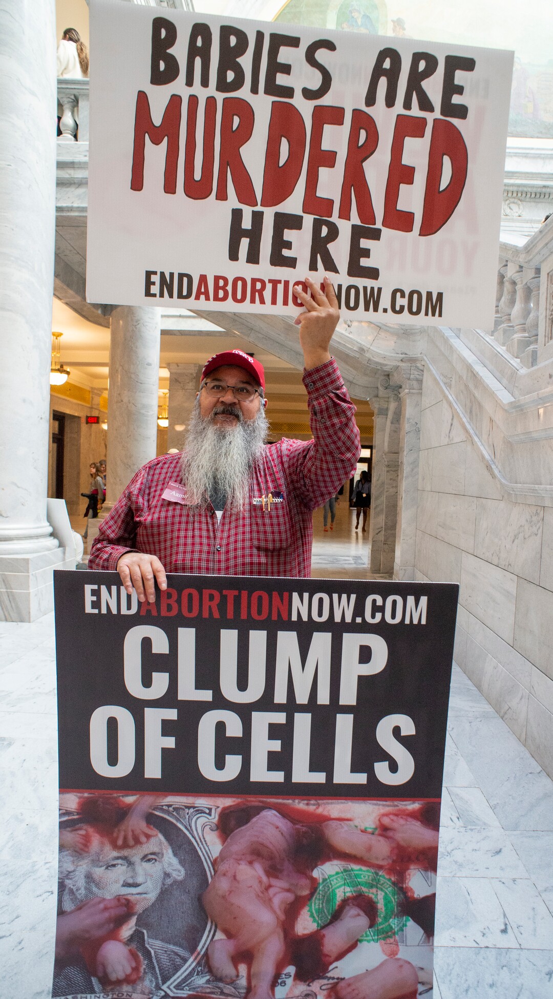 (Rick Egan  |  The Salt Lake Tribune)     Rudy Rodriguez holds a couple of signs, at the March for Life Utah rally at the Utah State Capitol, Saturday, Jan. 25, 2020.