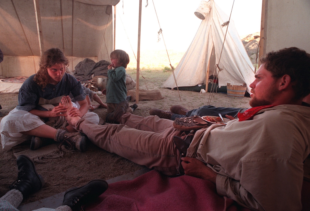 Rick Egan  | Tribune File Photo Wendy Westergard, Salt Lake City, gives a foot rub to Heber Dew, Sandy, in camp after a long day of walking.  Dew is pulling a hand cart along the trail.