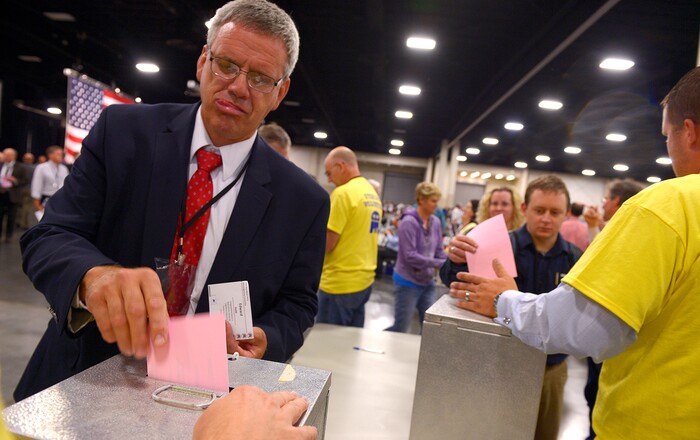 FILE - In this Aug. 15, 2015, file photo, Utah GOP delegate Ed Redd casts his vote for the offices of treasurer, secretary and vice-chair in Sandy, Utah. Utah's Republican Party is pressing on with a legal battle that's divided the state GOP and will argue before a Denver-based appeals court Monday, Sept. 25, 2017, that a state candidate nominating law violates its rights. The lawsuit is the Utah GOP's second attempt to chip away at the 2014 law, which allows candidates to bypass the party's nominating conventions and instead participate in a primary. (Leah Hogsten/The Salt Lake Tribune via AP, File)