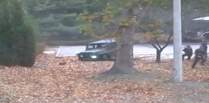 This image made from Nov. 13, 2017, surveillance video released by the United Nations Command shows a North Korean soldier running from a jeep and later shot by North Korean soldiers in Panmunjom, North Korea. A North Korean soldier made a desperate dash to freedom in a jeep and then on foot, being shot at least five times as he limped across the border and was rescued by South Korean soldiers, according to dramatic video released by the U.S.-led U.N. command Wednesday, Nov. 22, 2017. (United Nations Command via AP)