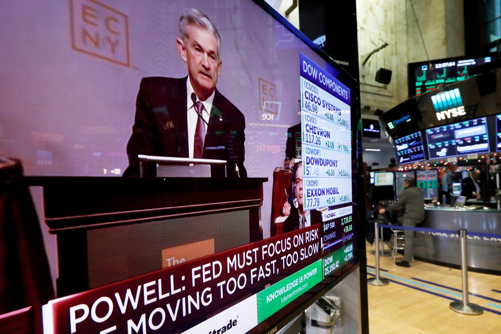 The speech of Federal Reserve Chairman Jerome Powell, to the Economic Club of New York, appears on a television screen on the floor of the New York Stock Exchange, Wednesday, Nov. 28, 2018. Powell cast a bright picture of the U.S. economy Wednesday and appeared to suggest that the Fed might consider a pause in its interest rate hikes next year to assess the impact of its credit tightening. (AP Photo/Richard Drew)
