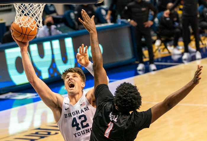 (Rick Egan | The Salt Lake Tribune)  Brigham Young Cougars center Richard Harward (42) shoots as Pacific Tigers forward Jordan Bell (1) defends, in overtime action, between Brigham Young Cougars and Pacific Tigers, at the Marriott Center in Provo, on Saturday, Jan. 30, 2021.