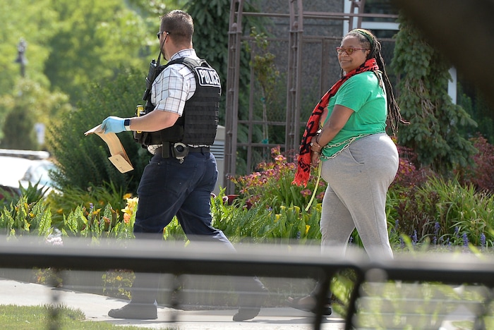 (Francisco Kjolseth  |  The Salt Lake Tribune)  Activists are escorted out of a building where they staged a protest against a private prison company with contracts to hold undocumented immigrants on Thursday, July 12, 2018, at the headquarters of Management and Training Corporation in Centerville.