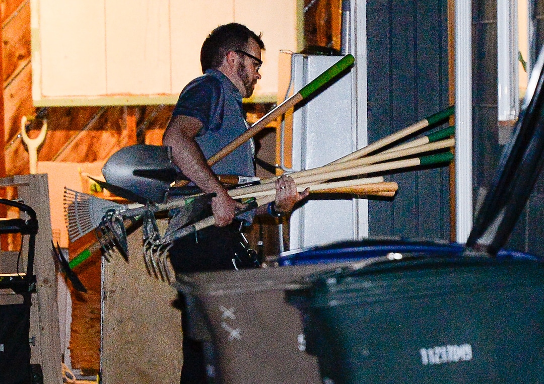 (Francisco Kjolseth  |  The Salt Lake Tribune)  Police investigators carry in multiple rakes and shovels into the backyard of a home at 547 N. 1000 West in Salt Lake City as part of the disappearance of University of Utah student MacKenzie Lueck on Wed. June 26, 2019.