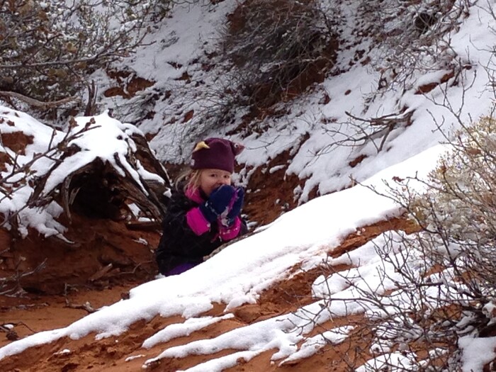 (Erin Alberty  |  The Salt Lake Tribune) 

A young hiker snacks on newly-fallen snow on the Broken Arch Loop hike in Arches National Park.