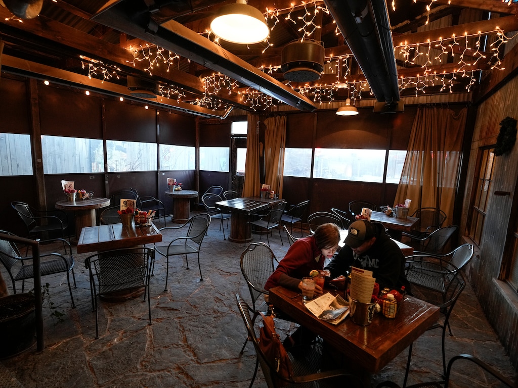 (Leah Hogsten | The Salt Lake Tribune)  Rachel and Aaron of Salt Lake City enjoy dinner and drinks on the semi-enclosed patio at The Garage, Jan. 18, 2022.