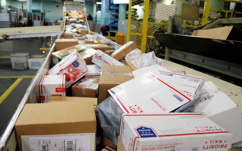 FILE- In this Dec. 14, 2017, file photo, packages travel on a conveyor belt for sorting at the main post office in Omaha, Neb. States will be able to force shoppers to pay sales tax when they make online purchases under a Supreme Court decision Thursday, June 21, 2018, that will leave shoppers with lighter wallets but is a big win for states. (AP Photo/Nati Harnik, File)