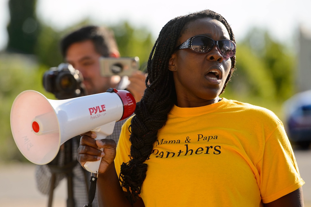 (Trent Nelson  |  The Salt Lake Tribune)Josianne Petit speaks at a protest organized by Black Lives Matter and other groups at the Woods Cross Police Department on Friday June 14, 2019. The rally was to show support for DJ Hrubes, a 10-year-old black child who was held at gunpoint by a police officer last week while playing in his grandmother's front yard.