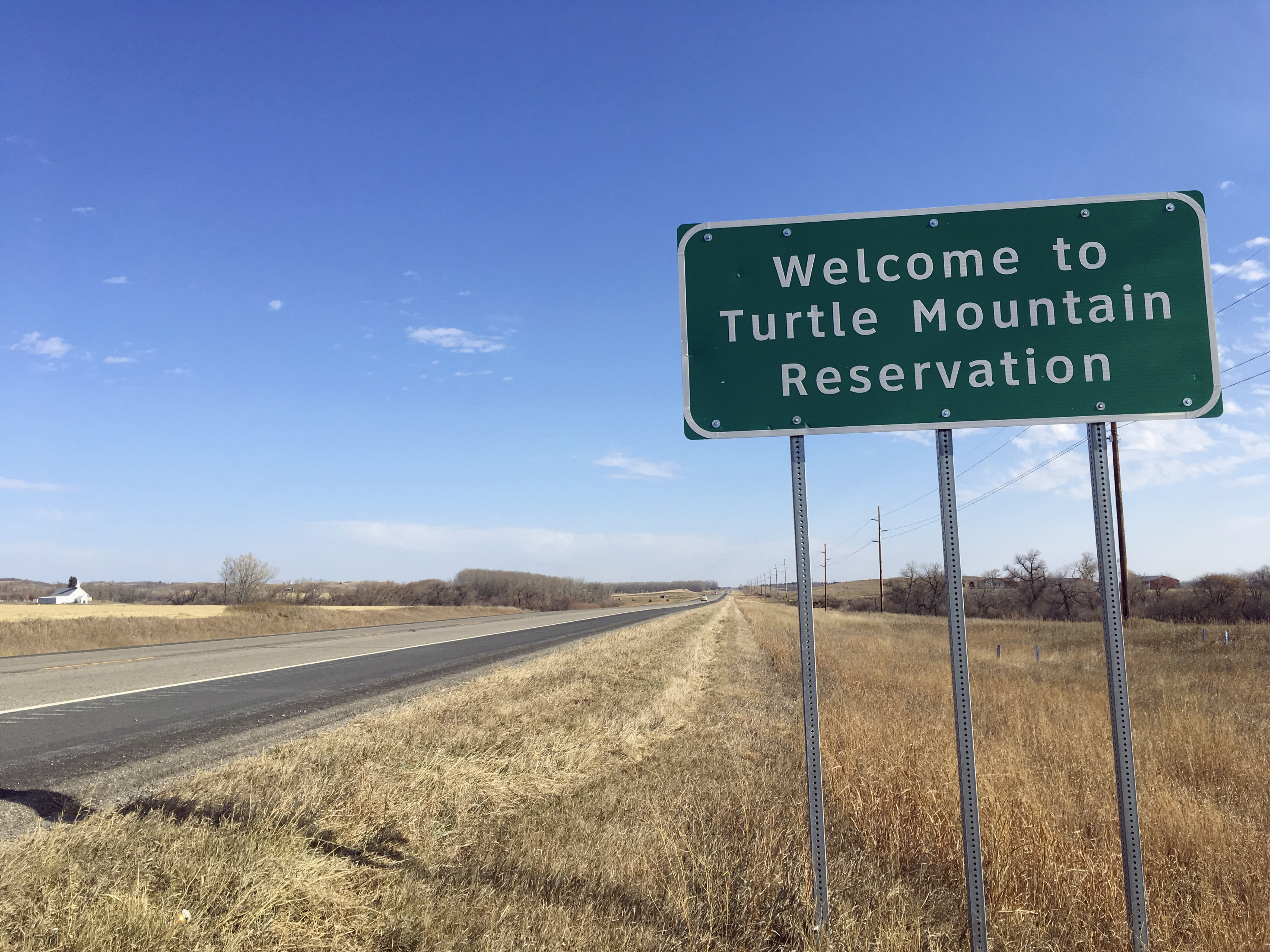 (Blake Nicholson | The Associated Press) In this Wednesday, Oct. 24, 2018, file photo, a sign to the Turtle Mountain Reservation of Native Americans in North Dakota is shown before Election Day amid concerns over voter ID. A new report released Thursday, Dec. 20, 2018, by the U.S. Commission on Civil Rights finds that funding levels for Native American tribes are woefully inadequate despite the federal government's responsibility to provide for education, public safety, health care and other services under treaties, laws and other acts.