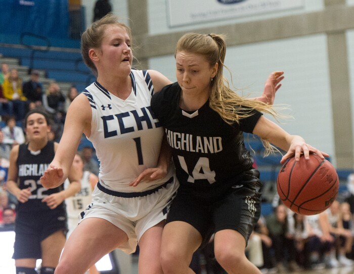 (Rick Egan | The Salt Lake Tribune) Highand High Rams Chelsey Cowburn (14) works the ball inside as Corner Canyon Chargers Hannah Sanderson (1) defends, in Class 5A women's basketball playoff game between Corner Canyon and Highland, Monday, Feb. 19, 2018.