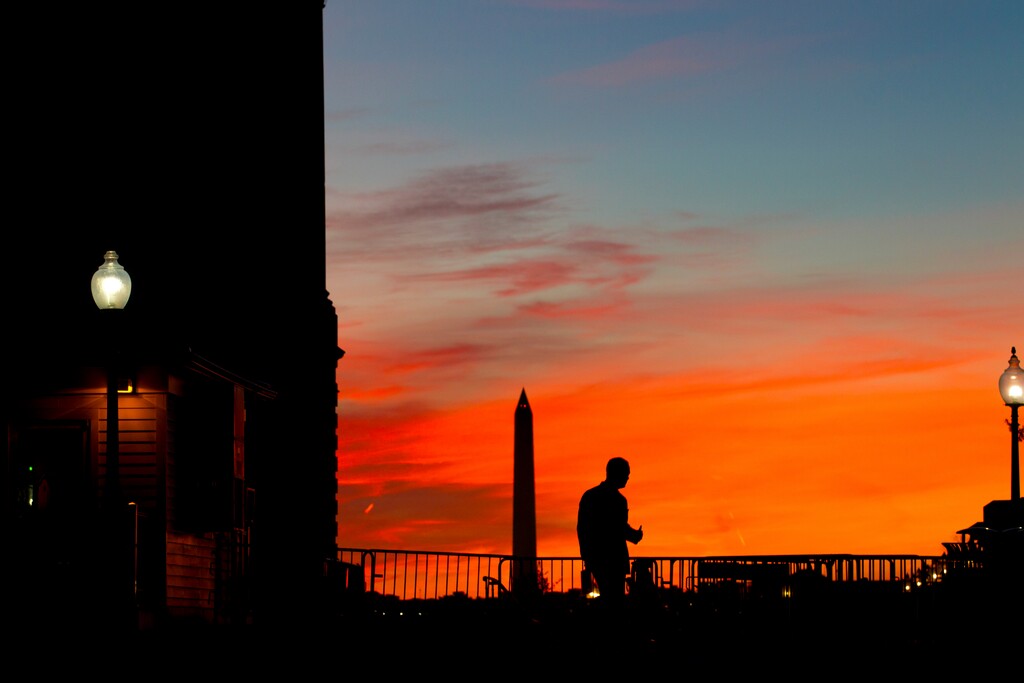 (Jose Luis Magana | The Associated Press) A pedestrian walks outside of the U.S. Capitol building Saturday, Jan. 20, 2018, in Washington, as Republicans and Democrats showed no signs of ending their standoff over immigration and spending Saturday as Americans awoke to the first day of a government shutdown. In the background is the Washington Memorial.