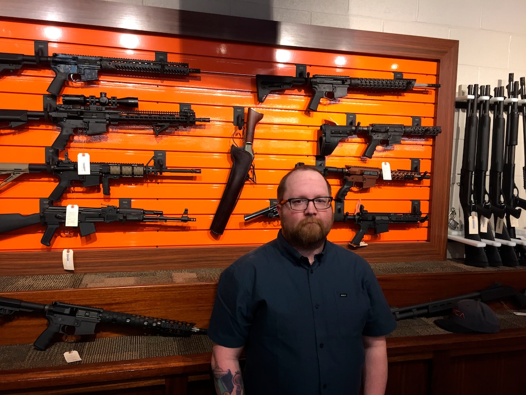 Josh O'Neal, general manager of the Rocky Mountain Gun Club in Grand Junction, Colorado, stands in front of a display of firearms at the state-of-the-art shooting range. O'Neal says safety is a high priority at the facility, but he and his staff are apprehensive regarding the possibility that a suicidal person might rent a gun at the site and then kill themselves. (AP Photo/David Crary) 