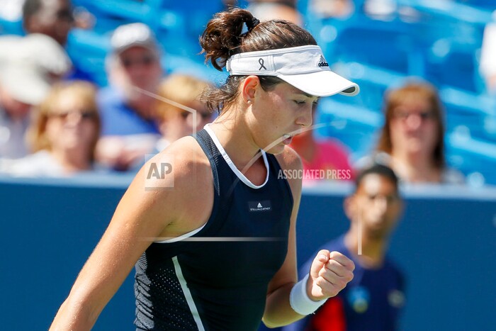 Garbine Muguruza, of Spain, reacts during a match against Svetlana Kuznetsova, of Russia, at the Western & Southern Open tennis tournament, Friday, Aug. 18, 2017, in Mason, Ohio. (AP Photo/John Minchillo)
