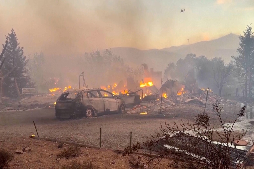 (Tim Walton via AP) An image taken from video shows a charred neighborhood following wildfires Saturday, Aug. 22, 2026, in Reno, Nevada.