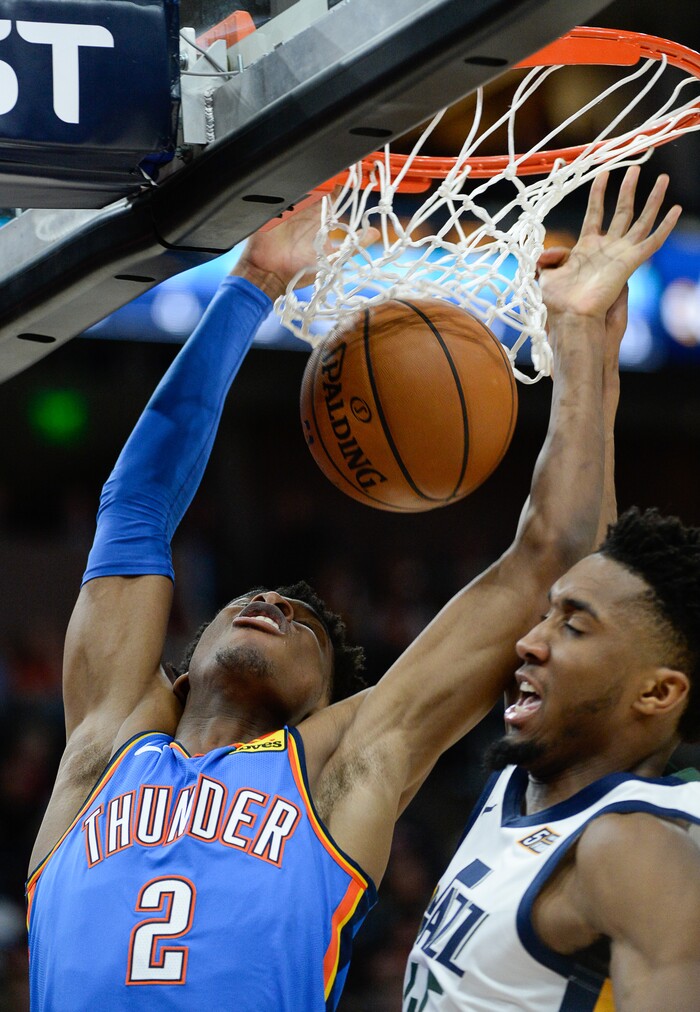 (Francisco Kjolseth  |  The Salt Lake Tribune)  Oklahoma City Thunder guard Shai Gilgeous-Alexander (2) gets the basket despite efforts try Utah Jazz guard Donovan Mitchell (45) as the Utah Jazz host the Oklahoma City Thunder in their NBA basketball game at Vivint Smart Home Arena in Salt Lake City on Mon. Dec. 9, 2019.