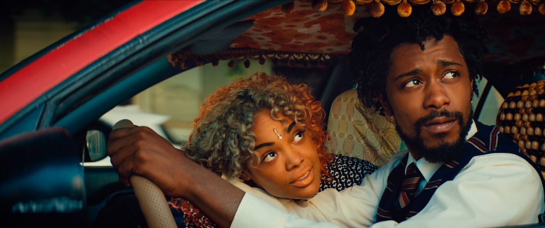 This image released by Annapurna Pictures shows Tessa Thompson, left, and Lakeith Stanfield in a scene from the film, "Sorry To Bother You." (Annapurna Pictures via AP)