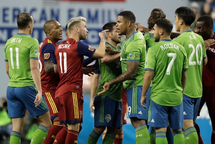Seattle Sounders and Real Salt Lake players, including RSL's Albert Rusnak (11) and Sounders' Roman Torres, third from right, scuffle during the first half of an MLS Western Conference semifinal playoff soccer match Wednesday, Oct. 23, 2019, in Seattle. (AP Photo/Ted S. Warren)