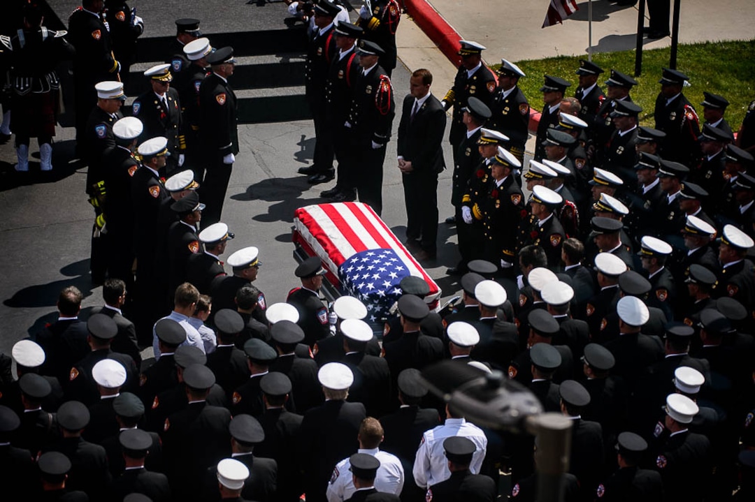 (Trent Nelson | The Salt Lake Tribune)  Funeral services for Battalion Chief Matthew Burchett at the Maverik Center in West Valley City, Monday Aug. 20, 2018.