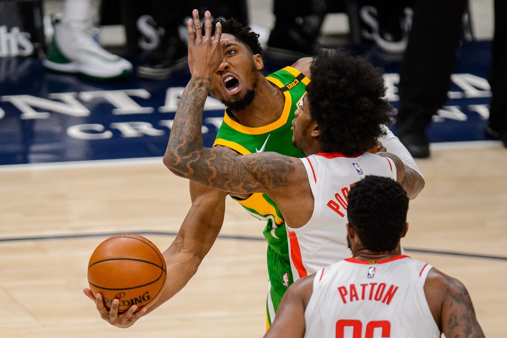 (Trent Nelson  |  The Salt Lake Tribune) Utah Jazz guard Donovan Mitchell (45) puts up a shot around Houston Rockets guard Kevin Porter Jr. (3) as the Utah Jazz host the Houston Rockets, NBA basketball in Salt Lake City on Friday, March 12, 2021.